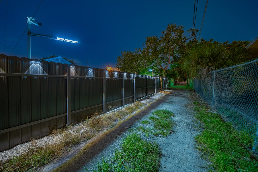 Night View of Parking Entrance w Remote Controlled Sliding Gate - Driving from the South heading North