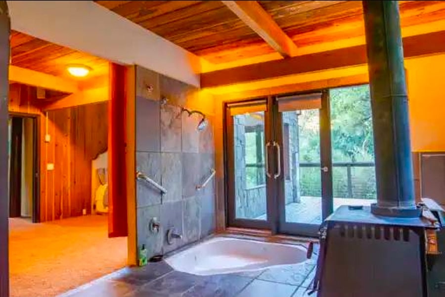 Sunken jacuzzi master with fireplace and bidet.
