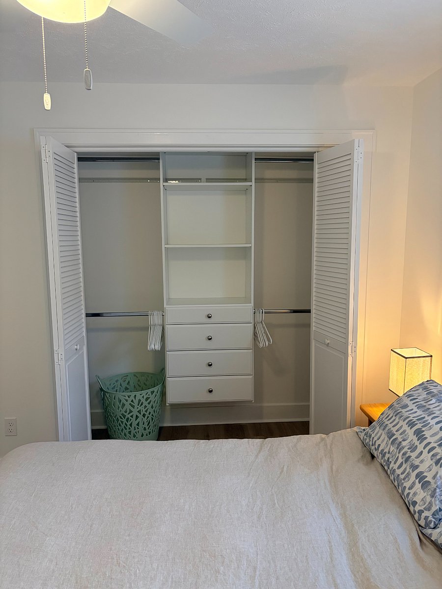 Built-ins for the second large closet with hangers and laundry basket
