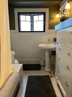 Clean, shared bathroom with classic finishes and lots of natural light