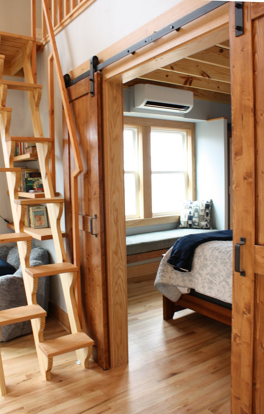 windowseat in bedroom, flanked by built in closets