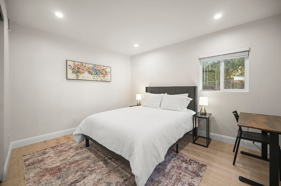 Main floor - bedroom 1 with queen size bed and height adjustable desk