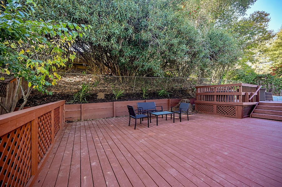 A large deck with seating space right outside of the living room for indoor outdoor living