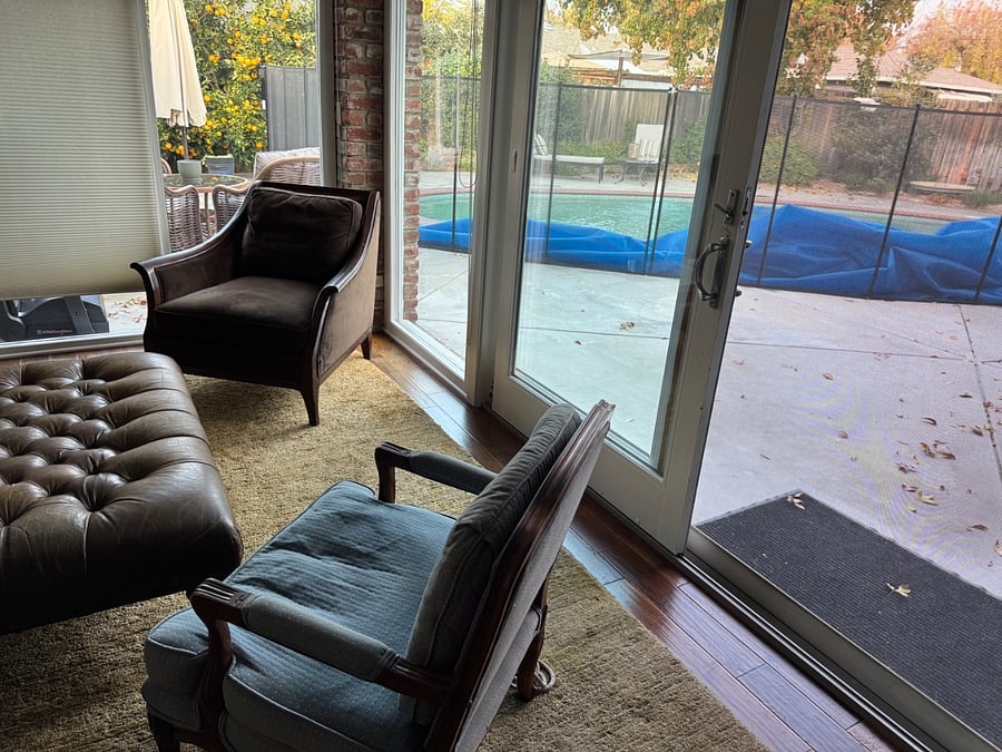 Solarium epitomizes the plethora of double pane, tempered glass, wooden frame Andersen windows and sliding doors. Visible: Baby Barrier pool fence recently installed for safety. Solar pool cover dramatically reduces pool water evaporation and increases warmth in season.