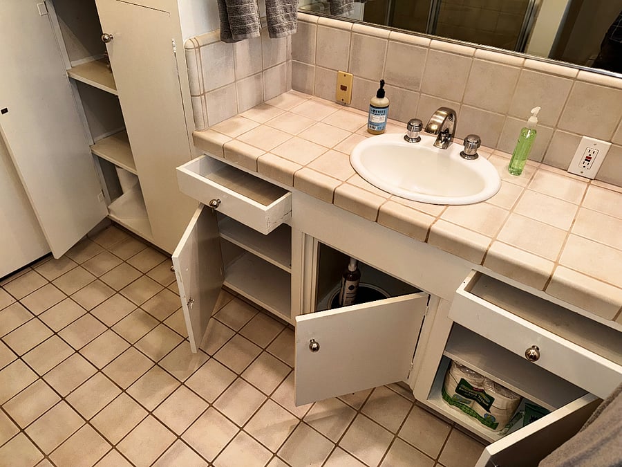 Guest bathroom has abundant cabinet space. Central air, exhaust fan, and garden window ensure plenty of fresh air, and generous lighting. Towels, cleaning supplies, and starter toiletries are all included.