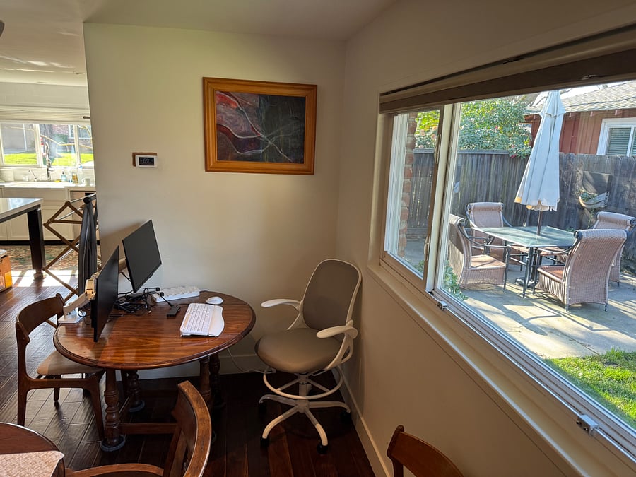 Workstation: Duel monitors, keyboard, and mouse and a sturdy office chair at a solid wood table.