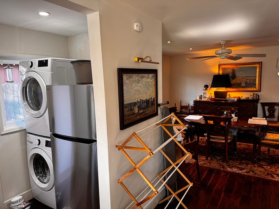 Two full sized refrigerators and full sized front loaders.