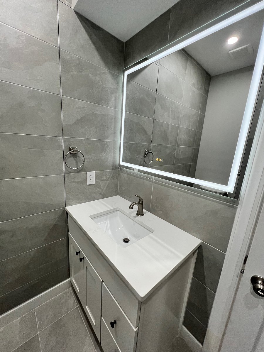 Modern bathroom with LED mirror and storage