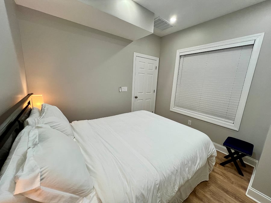 Bedroom view showing queen bed and window