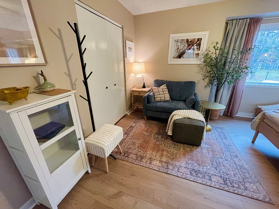 loveseat lounge area beside walk in closet