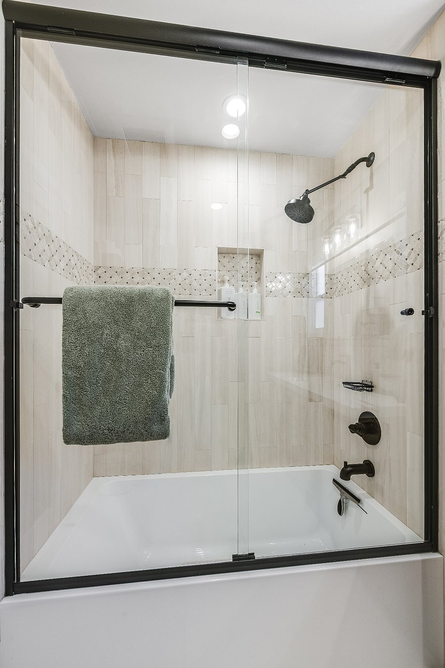 Bathtub and shower in the large bathroom.