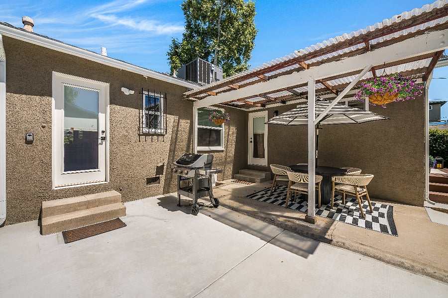 Covered outdoor dining set and gas barbecue, door is to the kitchen/laundry room.