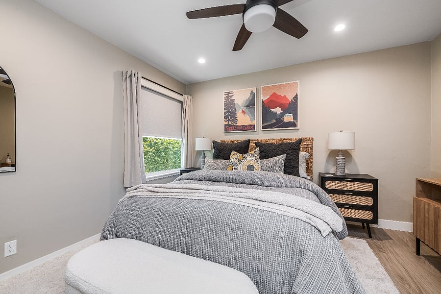 Queen bedded room with black out shades.