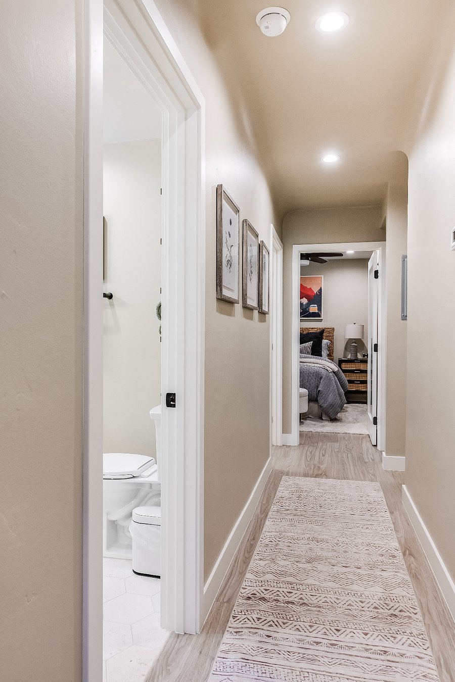 Hallway with two bedrooms and two bathrooms.