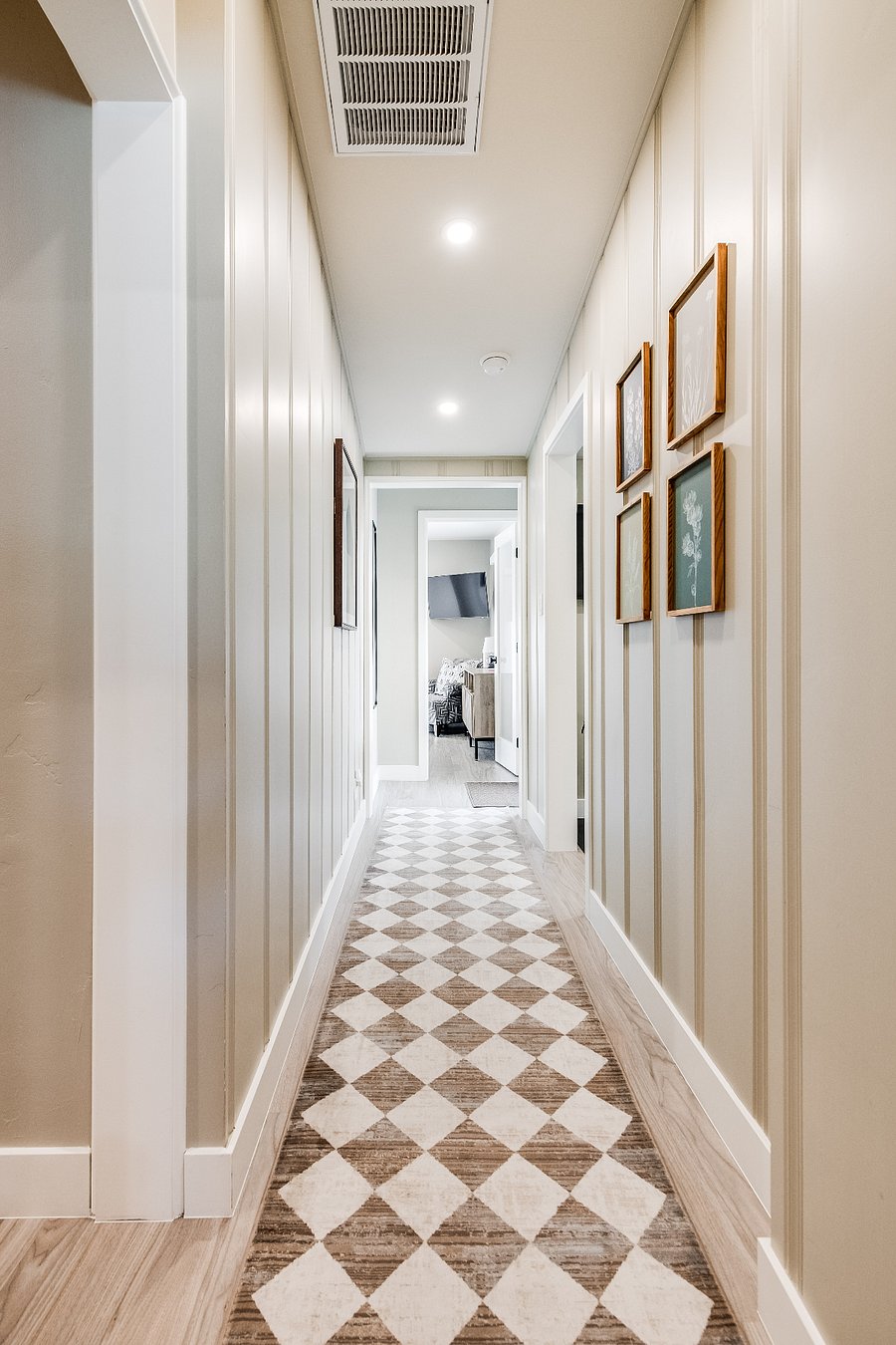 Hallway to yoga room and large king bedded room facing the backyard.