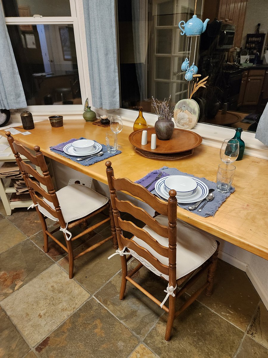 Dining area with view of backyard and open space.