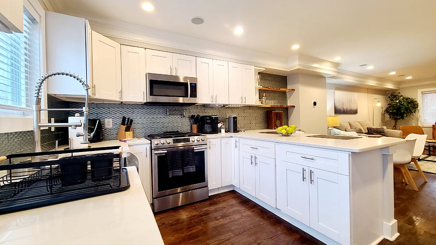Gourmet kitchen includes added features suck as slide in stove, pot filler and glass rinser