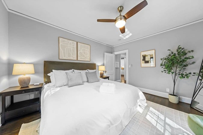 White bed bright side lamp with aesthetic plant
