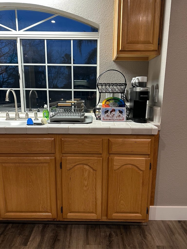 Kitchen with full size fridge, oven/air fryer, michrowave, two-burner countertop cooktop, tea pot, blender, hand mixer, ample counter space and kitchen essentials