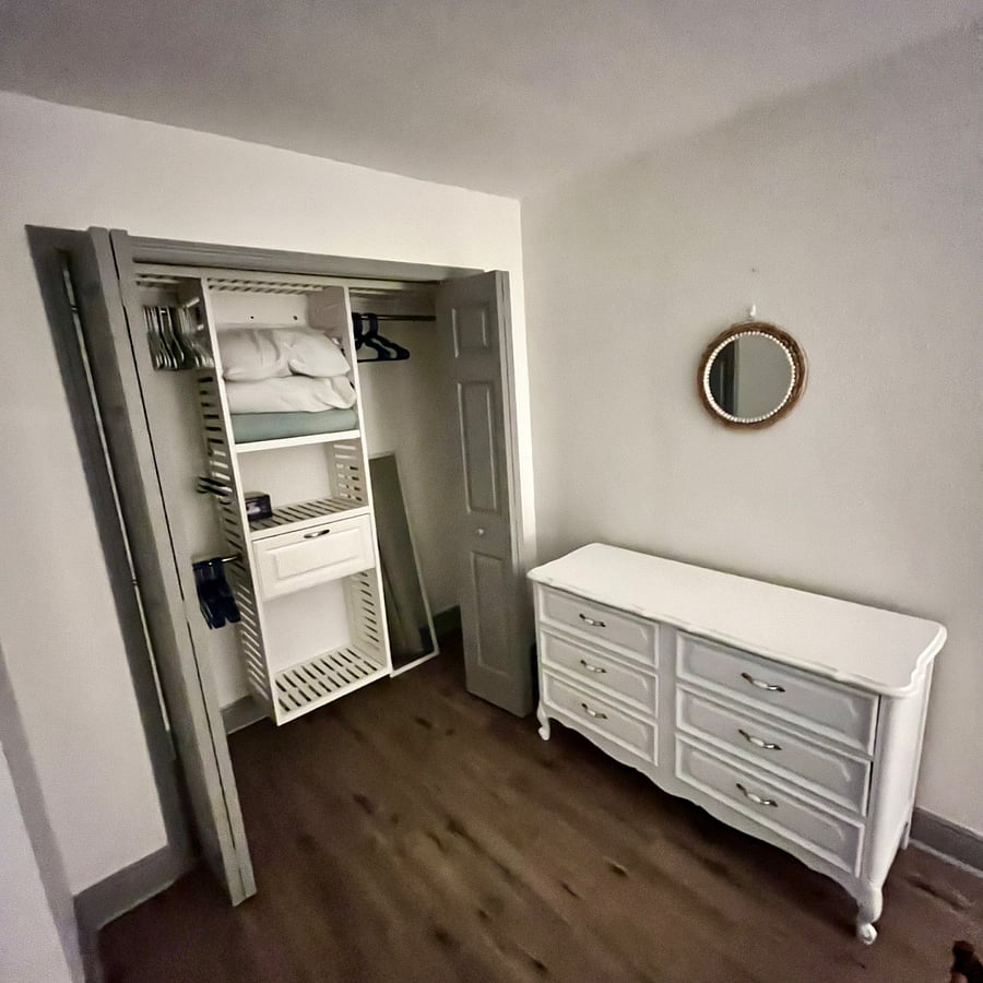 Master bedroom closet - Full sized dresser, floor length mirror, extra linens and blankets.