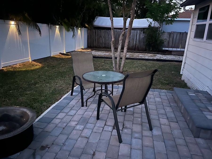 Fully fenced in backyard with paver patio and fire pit. Trailer, camper or boat can be parked on the shellstone pad behind the double swing fence with previous approval.