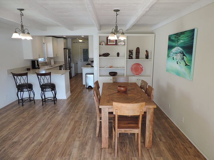 Dining room and kitchen bar with pool and marina views.