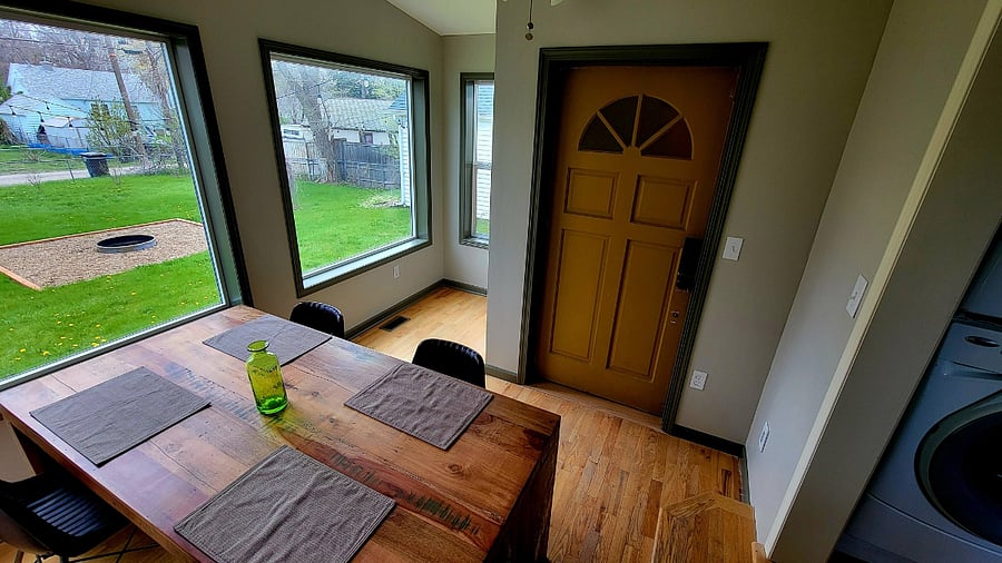 Dining room, rear entrance, and backyard with firepit.