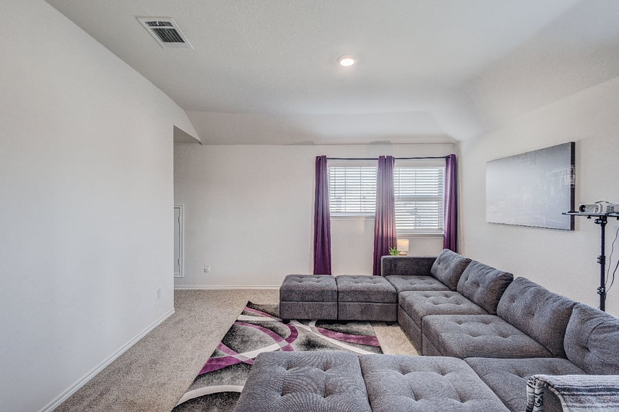 Spacious upstairs loft living area exclusive to tenants, features a large sectional, great natural light, and plenty of room to unwind.