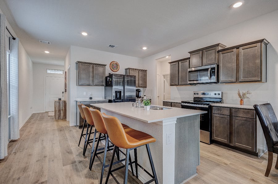 Modern kitchen with a spacious island, bar seating, stainless appliances, and plenty of counter space for meal prep.