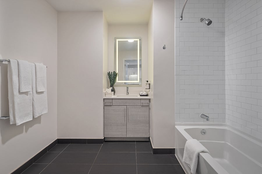 Polished surfaces and warm lighting set a tranquil mood.
Refresh and rejuvenate in this serene bathroom oasis.