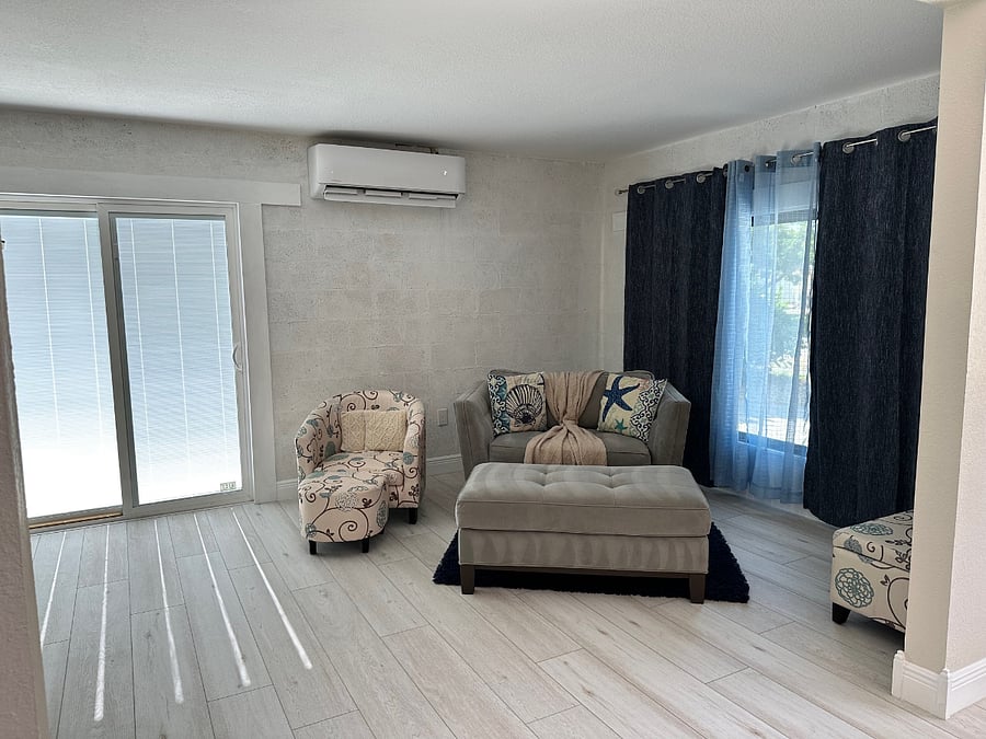 Family room with slider to driveway and casement window at front of house