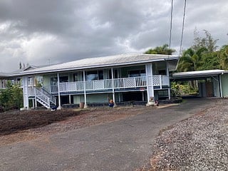 Facing the street with carport on the north side.