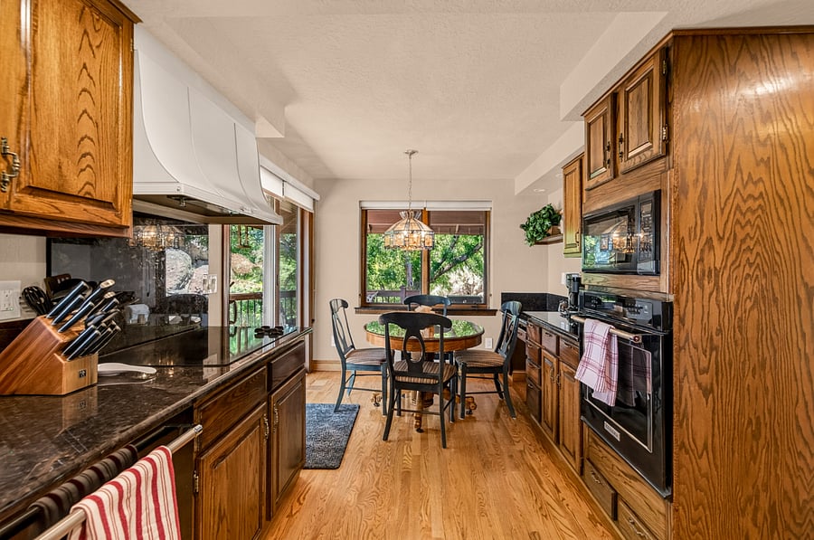 Fully equipped kitchen with new KitchenAid appliances and a kitchen nook for four (4) overlooking the backyard.