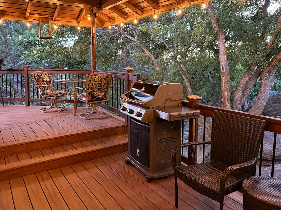 Main level patio area overlooks a very private and spacious backyard ; one table and rocker/swivel chairs for four (4), two additional smaller tables seating two (2) each, and a Weber Spirit grill