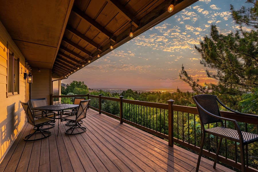The expansive private deck is one of the home's signature features, offering panoramic Treasure Valley views and unforgettable Idaho sunsets. Enjoy outdoor dining at the table for four, relax with a drink at one of two intimate cocktail seating areas for two, or fire up the Weber gas grill for an evening mealall surrounded by the privacy and tranquility of the wooded hillside.