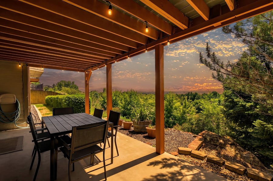 The covered lower-level patio provides a second outdoor living space with dining for six, making it ideal for family meals, entertaining, or relaxing in the shade. Overlooking the private wooded backyard and Treasure Valley, it's a peaceful retreat to enjoy Boise's beautiful evenings.