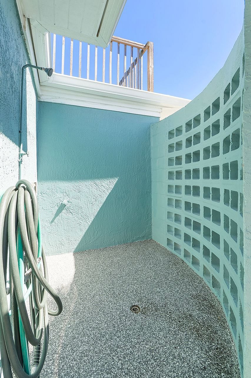 Outdoor shower behind the building to rinse off after a day at the beach