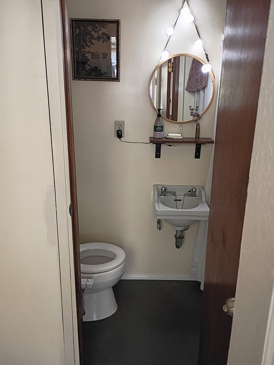 This small bathroom has private entrance near the tiny house if tenants would like to use it vs the compost toilet. Right in front of this bathroom is the laundry room.