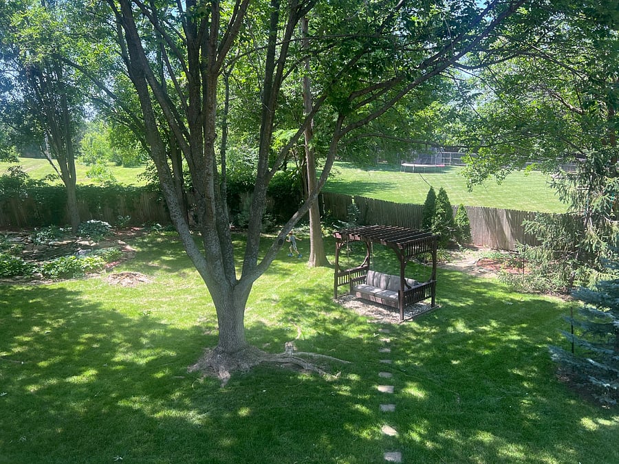 Deck view of fenced yard. Basement opens out to yard through private entrance.