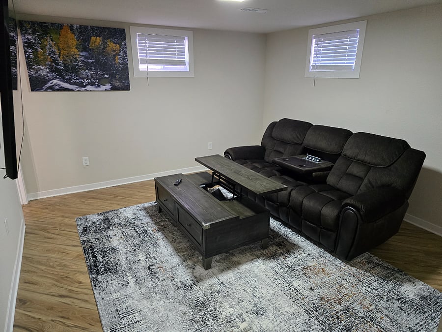 Downstairs adjustable couch with movable coffee table.