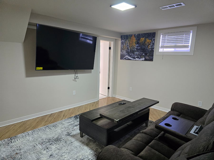 Downstairs adjustable couch with movable coffee table.