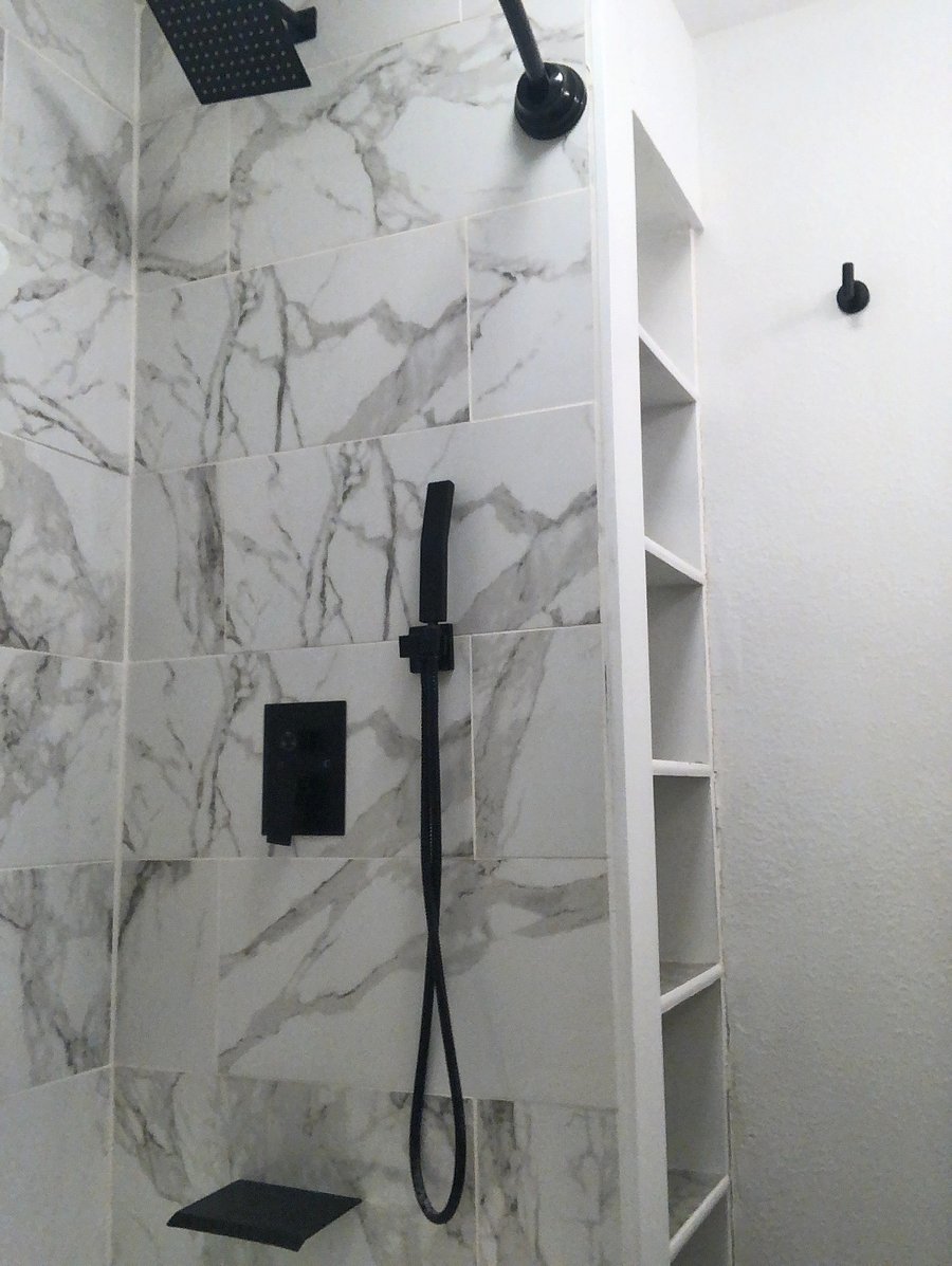 Bathroom with Tub & Shower, sink area, storage shelves, toilet & more. 
Shower Head & Faucet are waterfall flows & it also has a hand held sprayer option as well. 

