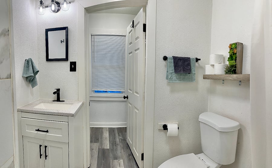 Bathroom with Tub & Shower, sink area, storage shelves, toilet & more. 
Shower Head & Faucet are waterfall flows & it also has a hand held sprayer option as well. 