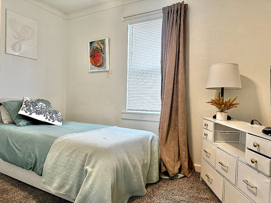 The "Sage Room" features a twin sized bed, with local artist work on the wall, small dresser with usb plugs to charge phones, small tv with local channels & closet. 