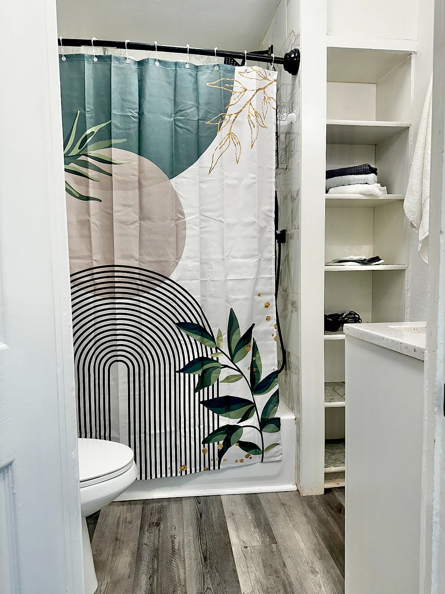 Bathroom with Tub & Shower, sink area, storage shelves, toilet & more. 
Shower Head & Faucet are waterfall flows & it also has a hand held sprayer option as well. 