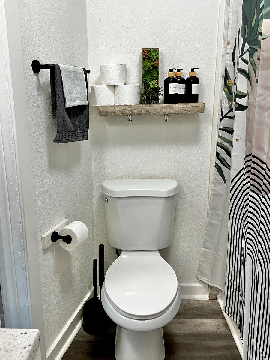 Bathroom with Tub & Shower, sink area, storage shelves, toilet & more. 
Shower Head & Faucet are waterfall flows & it also has a hand held sprayer option as well. 