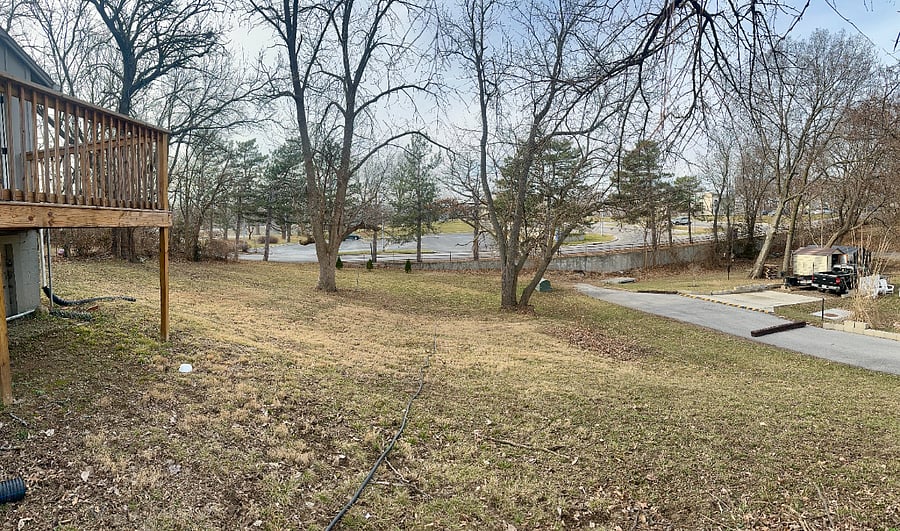 Wide view of the back yard, as it's on a corner lot with the side street that is a dead end to the parking lot of the Truman Library. So pretty relaxed back there most of the time! 