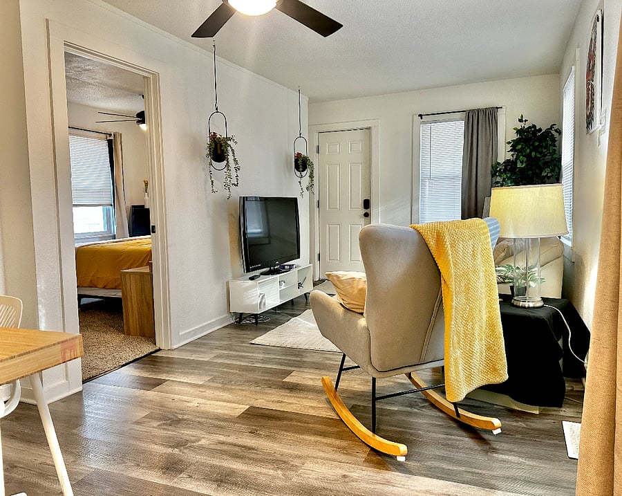 Living room with rocking chair & extra blankets to snuggle up with. 