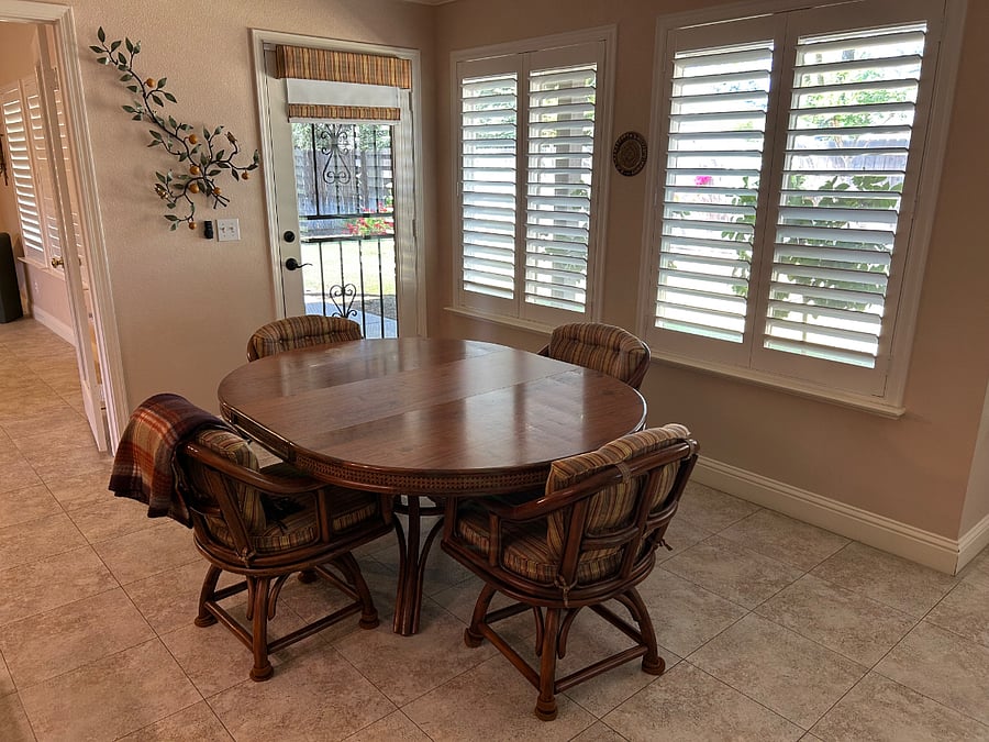 Shared kitchen table with view of backyard, lots of natural light and door that opens to covered patio.