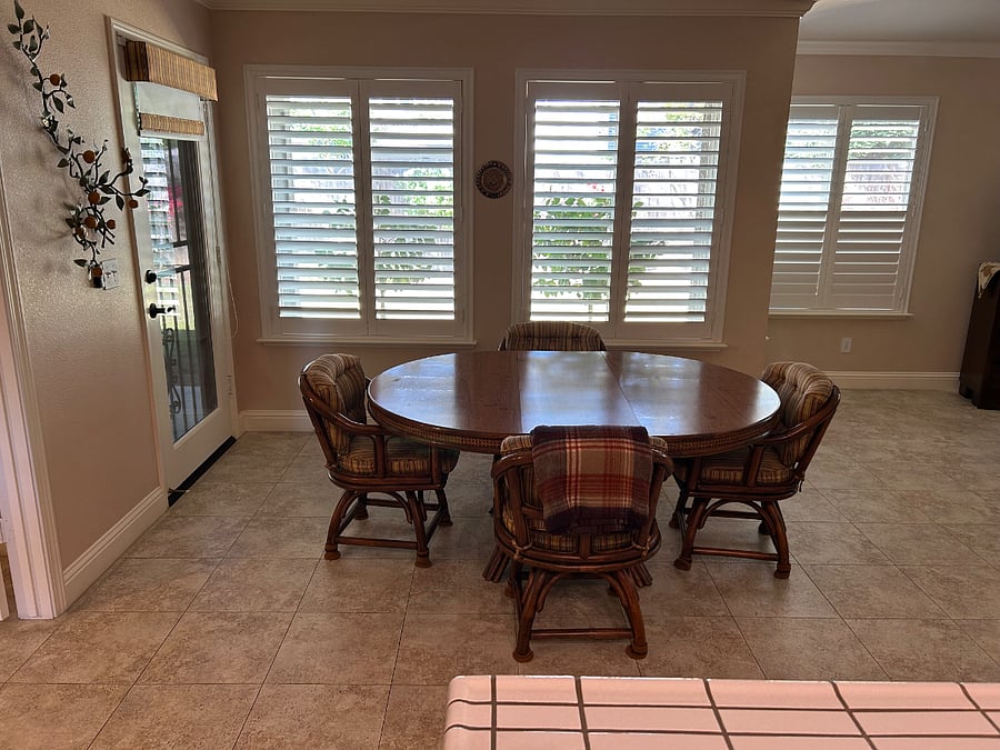 Shared kitchen table with view of backyard, lots of natural light and door that opens to covered patio.